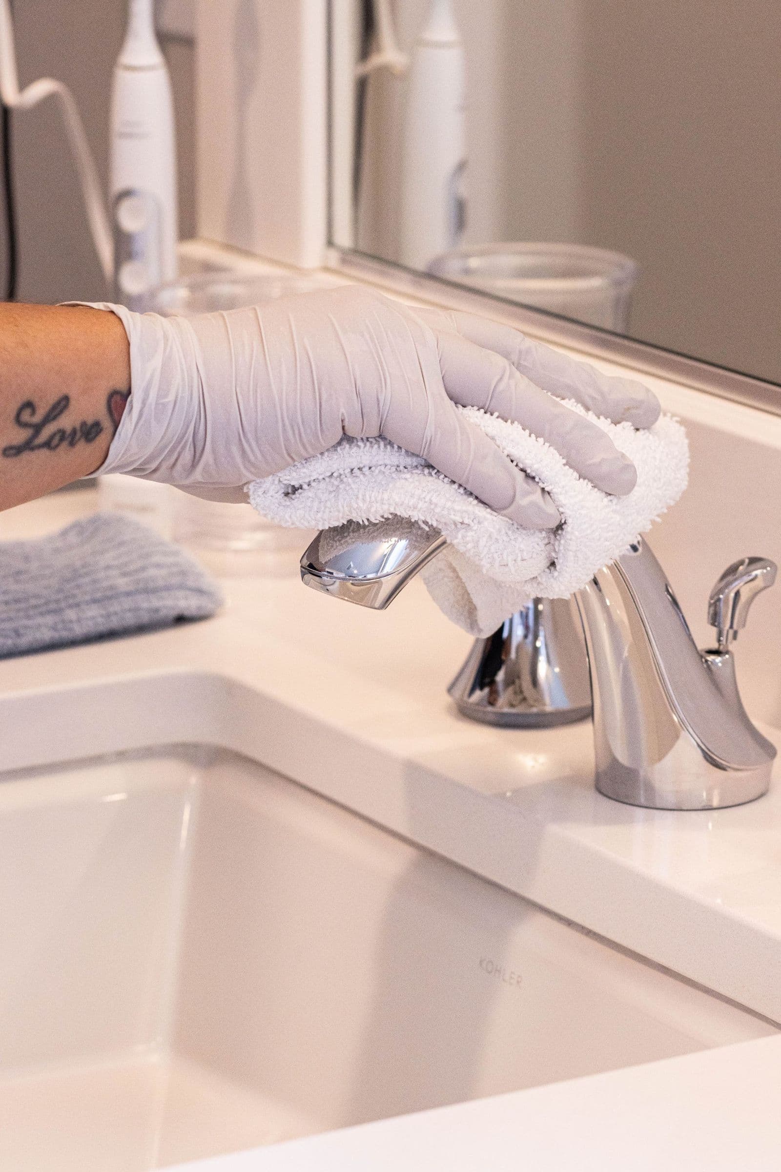 Polishing bathroom fixtures in a Duvall home before the owners leave on a summer trip
