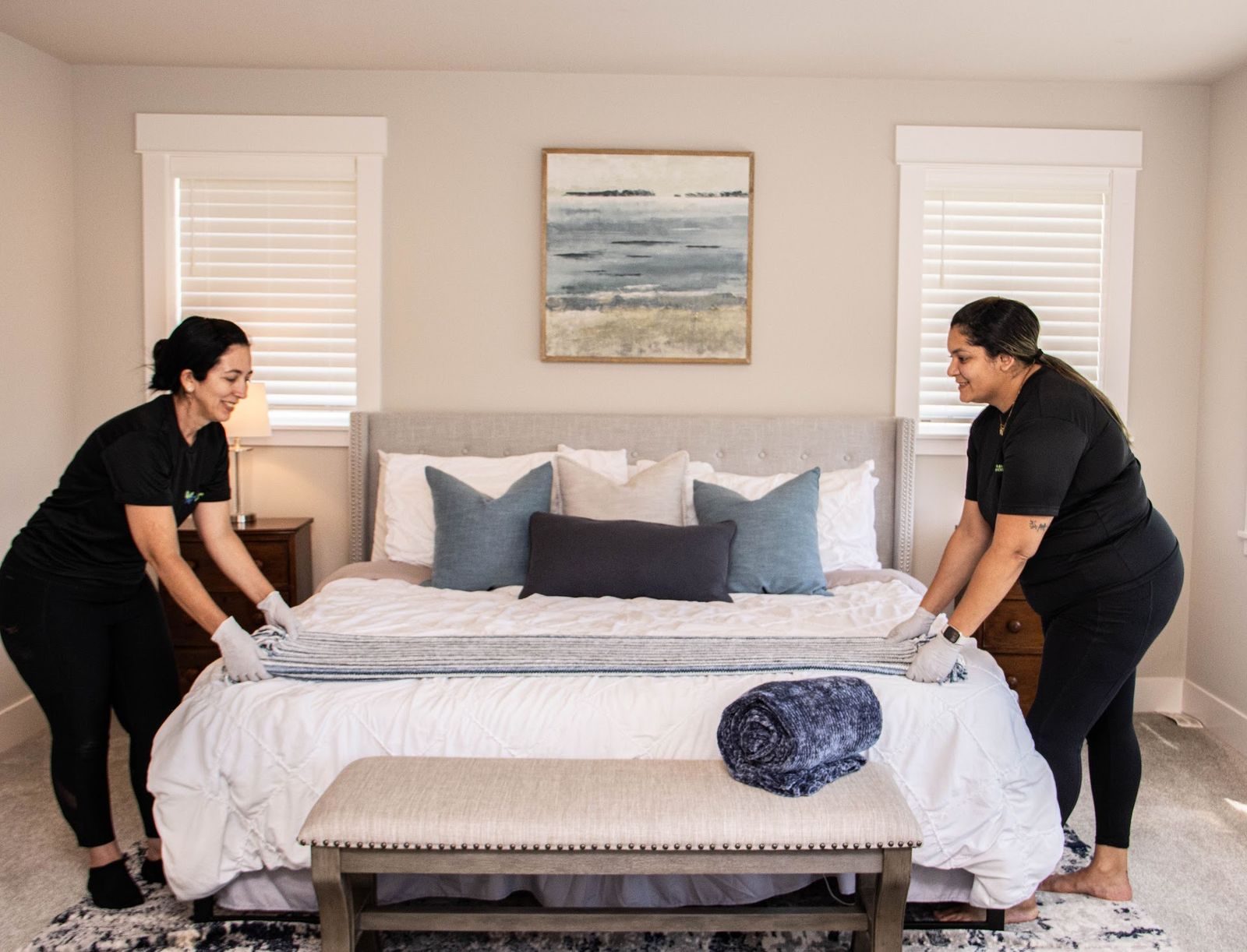 Nova Cleaning team members resetting a guest room in a Duvall home before summer visitors